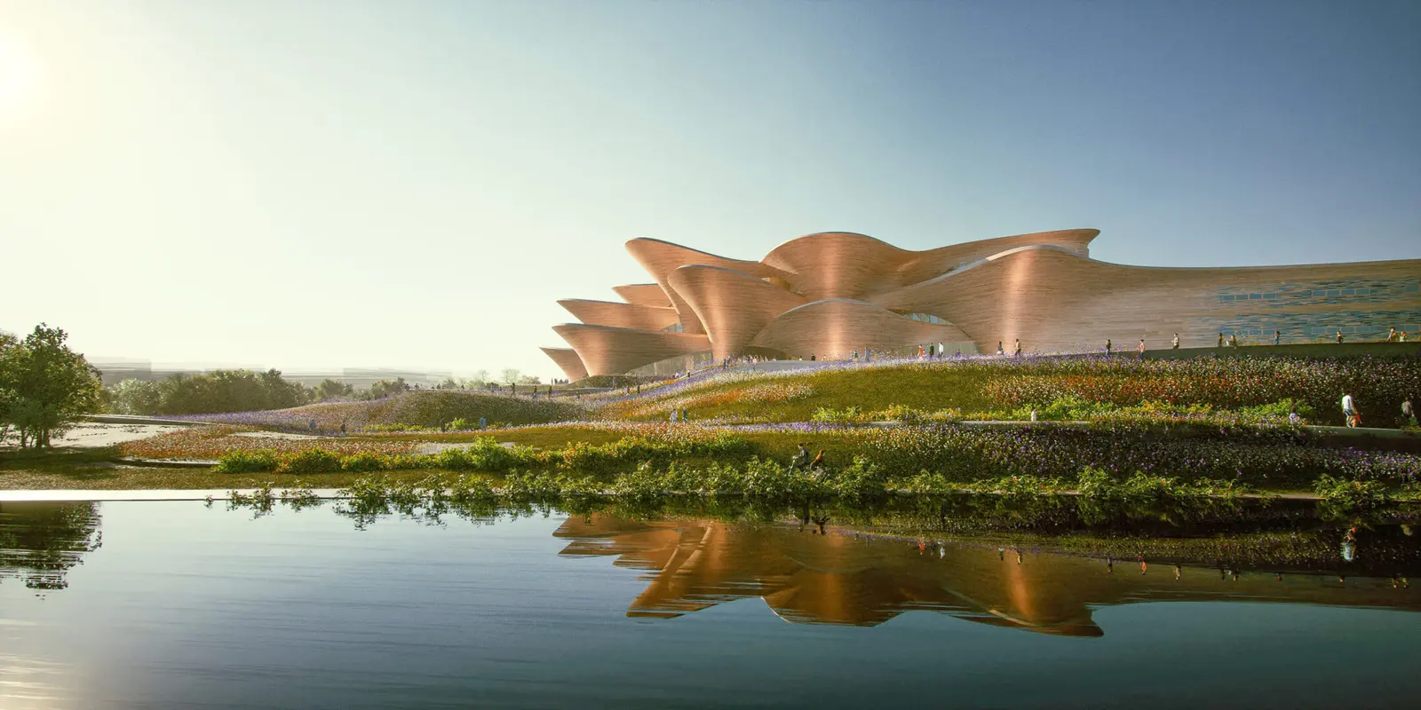 Rendering des gewölbten Backsteinbaus hinter einer blühenden Uferwiese, gespiegelt im ruhigen Wasser davor.