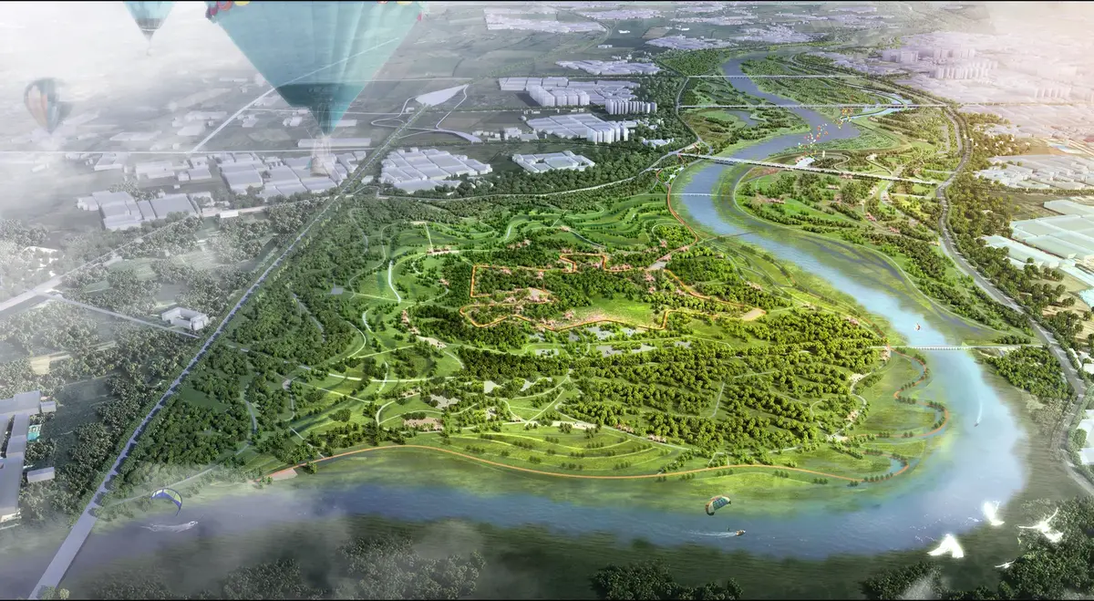 Aerial rendering of a forested park in a river bend with hot-air balloons above.